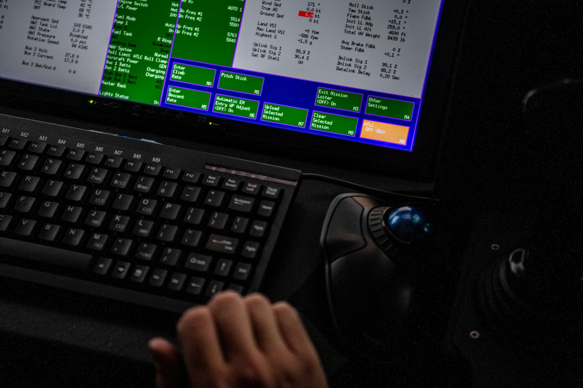 An MQ-9 Reaper pilot prepares to enable the automated takeoff and landing capability in a ground control unit.