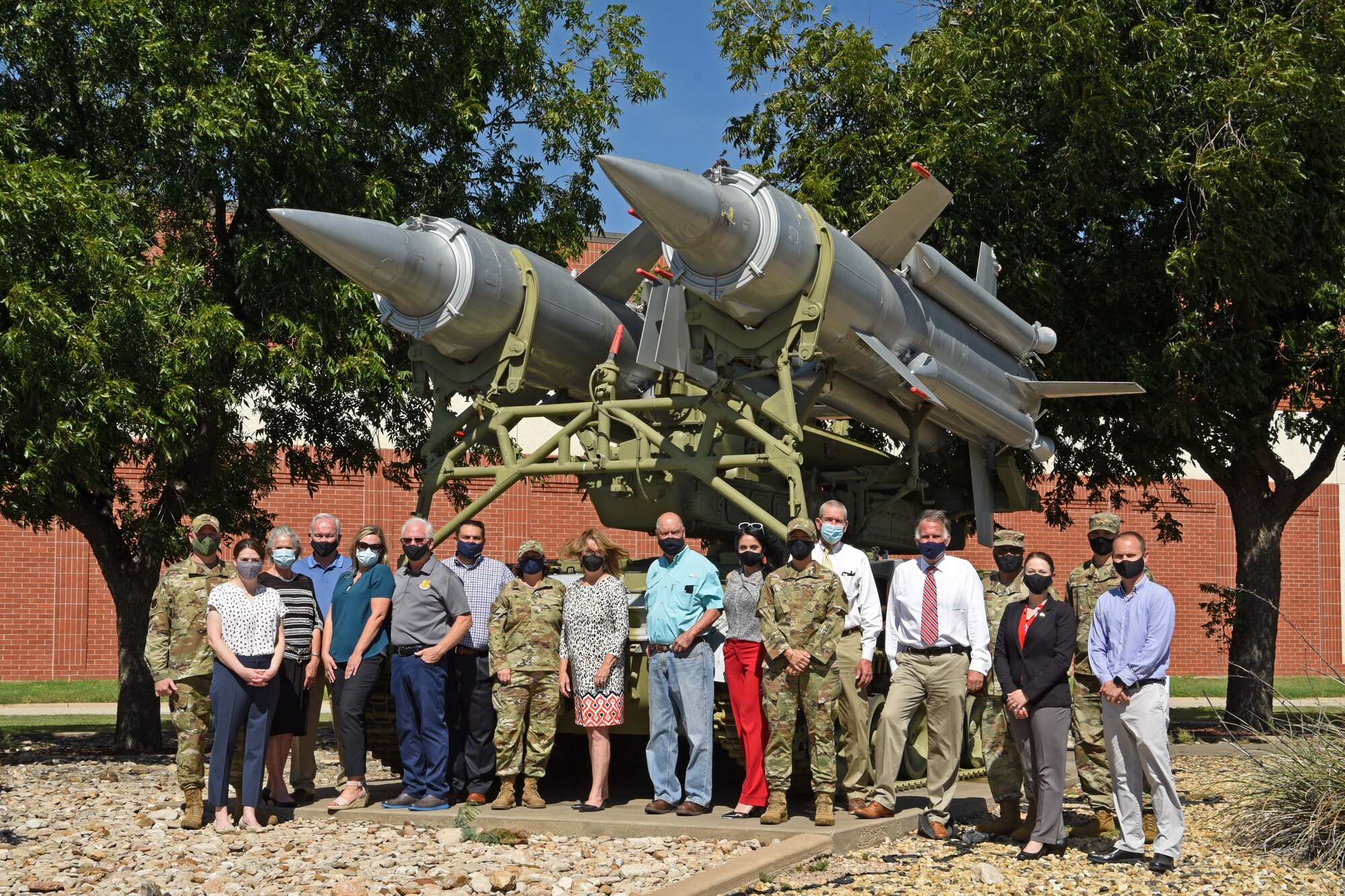 San Angelo civic leaders and Goodfellow Air Force Base leadership pose for a photo in front of the SA-4 Ganef on Goodfellow Air Force Base, Texas, Aug. 24, 2021. The SA-4 Ganef was a surface to air missile system and is used as a static display to enhance training on base.  (U.S. Air Force photo by Senior Airman Abbey Rieves)