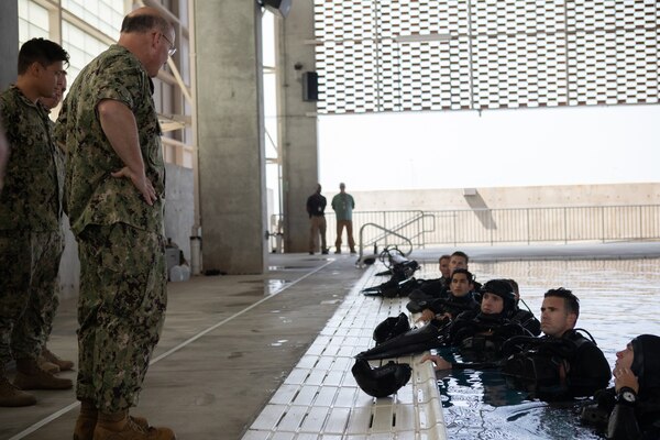 CORONADO, Calif. (August 23, 2021) Chief of Naval Operations Adm. Mike Gilday talks with Sailors following a combat swimmer demonstration at the combat training tank during a visit to Naval Special Warfare Command and the San Diego region today. During the visit, Gilday spent time with NSW personnel to discuss assessing and selecting leaders with character, cognitive and leadership attributes, strengthening the NSW force and their families, and integrating NSW with the Fleet. Naval Special Warfare is the Nation’s premier maritime special operations force – a highly reliable and lethal force – and is uniquely positioned to extend the Fleet’s reach and deliver all-domain options for Naval and Joint Force commanders. (U.S. Navy photo by Mass Communication Specialist 3rd Class Tobias Levene)