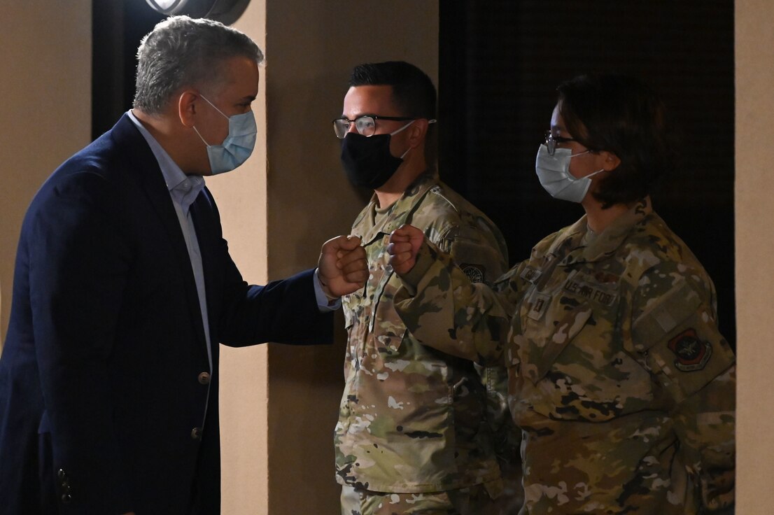 President Ivan Duque of Colombia, greets U.S. Air Force Capt. Mary Guzman-Muro, 375th Aeromedical Evacuation Squadron flight nurse at Base Operations on Scott Air Force Base, Illinois, August 23, 2021. Guzman-Muro helped act as one of the translators for numerous Colombian business leaders, state media, and others as they processed with United States Customs and Border Protection. (U.S. Air Force photo by Staff Sgt. Dalton Williams)