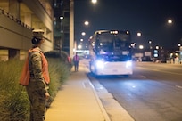 U.S. Army Soldiers assigned to 804th Transportation Detachment, 382nd Combat Sustainment Support Battalion, help guide buses into position  in support of Operation Allies Refuge, July 29, 2021 at the Dulles International Airport in Virginia.