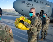 Soldiers from 2nd Armored Brigade Combat Team, 1st Armored Division assist as the first flight of Afghans arrive at Fort Bliss, Texas, Aug. 21, 2021.