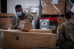 Task Force McGuire-Dix Airmen prepare personal protective equipment to aid in the arrival of Afghans  in support of the Department of State-led Operation Allies Refuge on Joint Base McGuire-Dix-Lakehurst, New Jersey, Aug. 21, 2021.