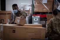 Task Force McGuire-Dix Airmen prepare personal protective equipment to aid in the arrival of Afghans  in support of the Department of State-led Operation Allies Refuge on Joint Base McGuire-Dix-Lakehurst, New Jersey, Aug. 21, 2021.