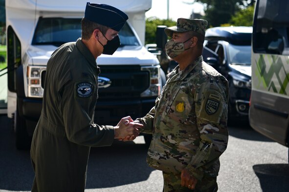 Commanders greet each other during a visit.