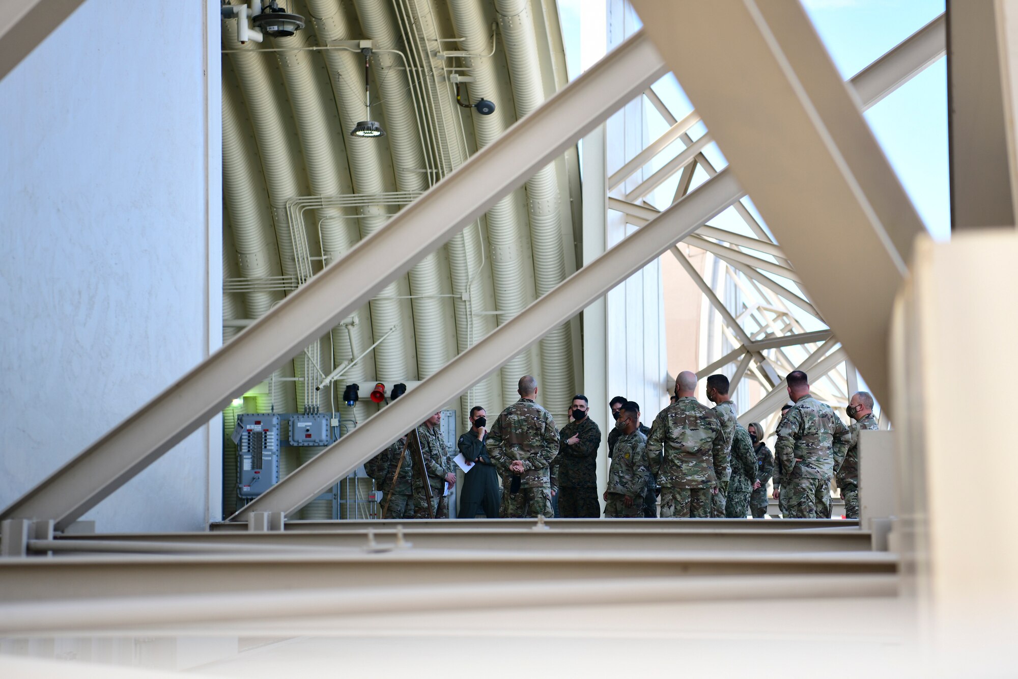 Commanders gather under a hangar.