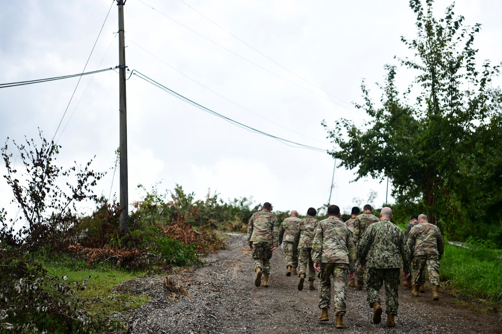 Airmen walk up a hill.