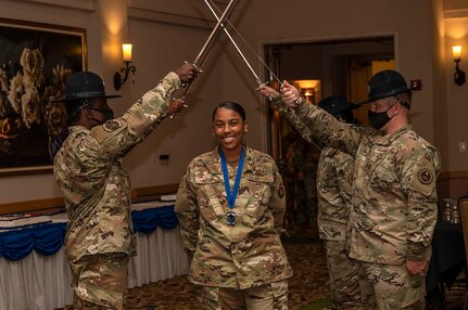 Female NCO passes under saber cordon