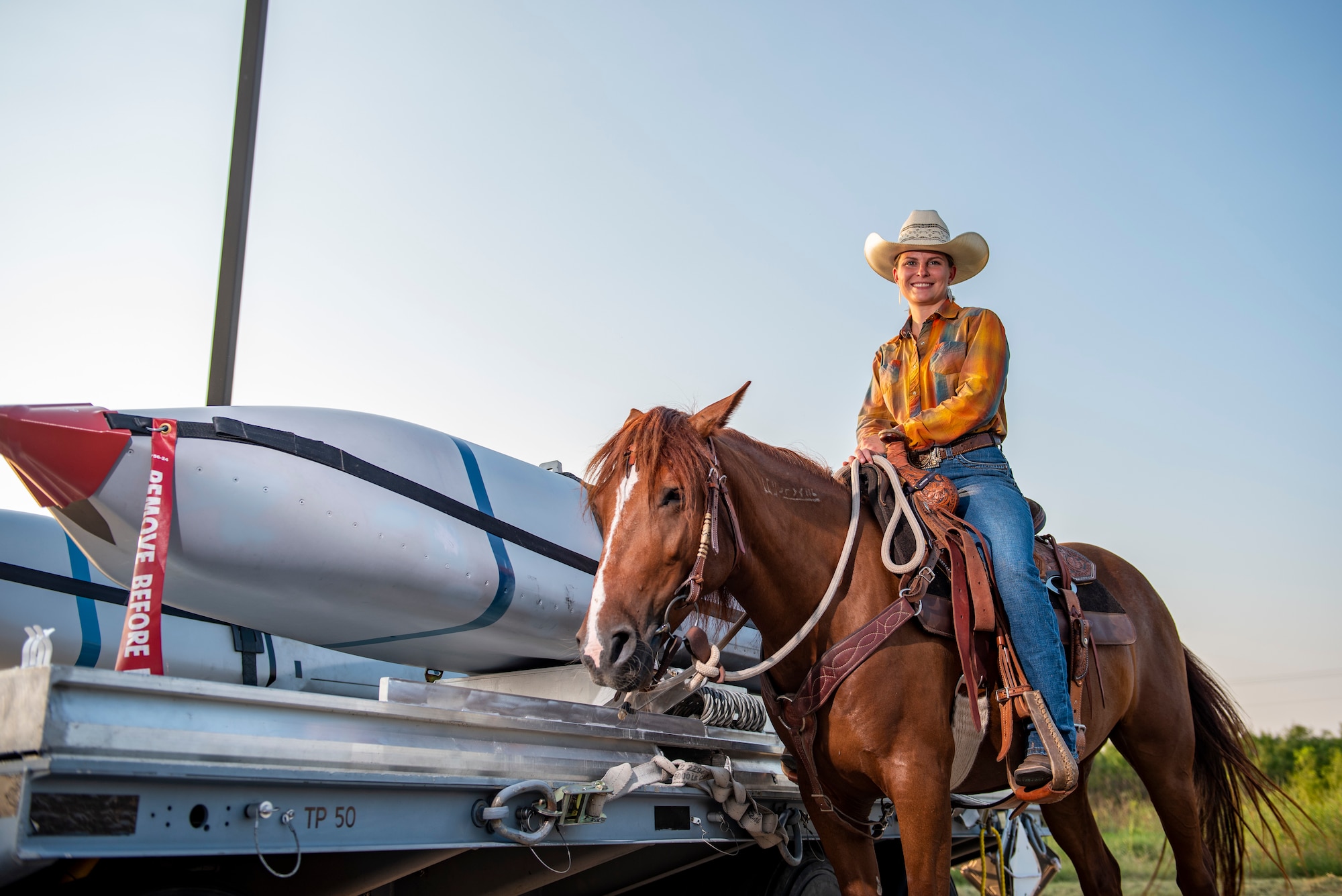 Staff Sgt. Melissa Sekerak, 7th Munitions Squadron stockpile management supervisor, poses for a photo with her horse, Malibu, next to an inert munition at Dyess Air Force Base, Texas, Aug. 5, 2021.
