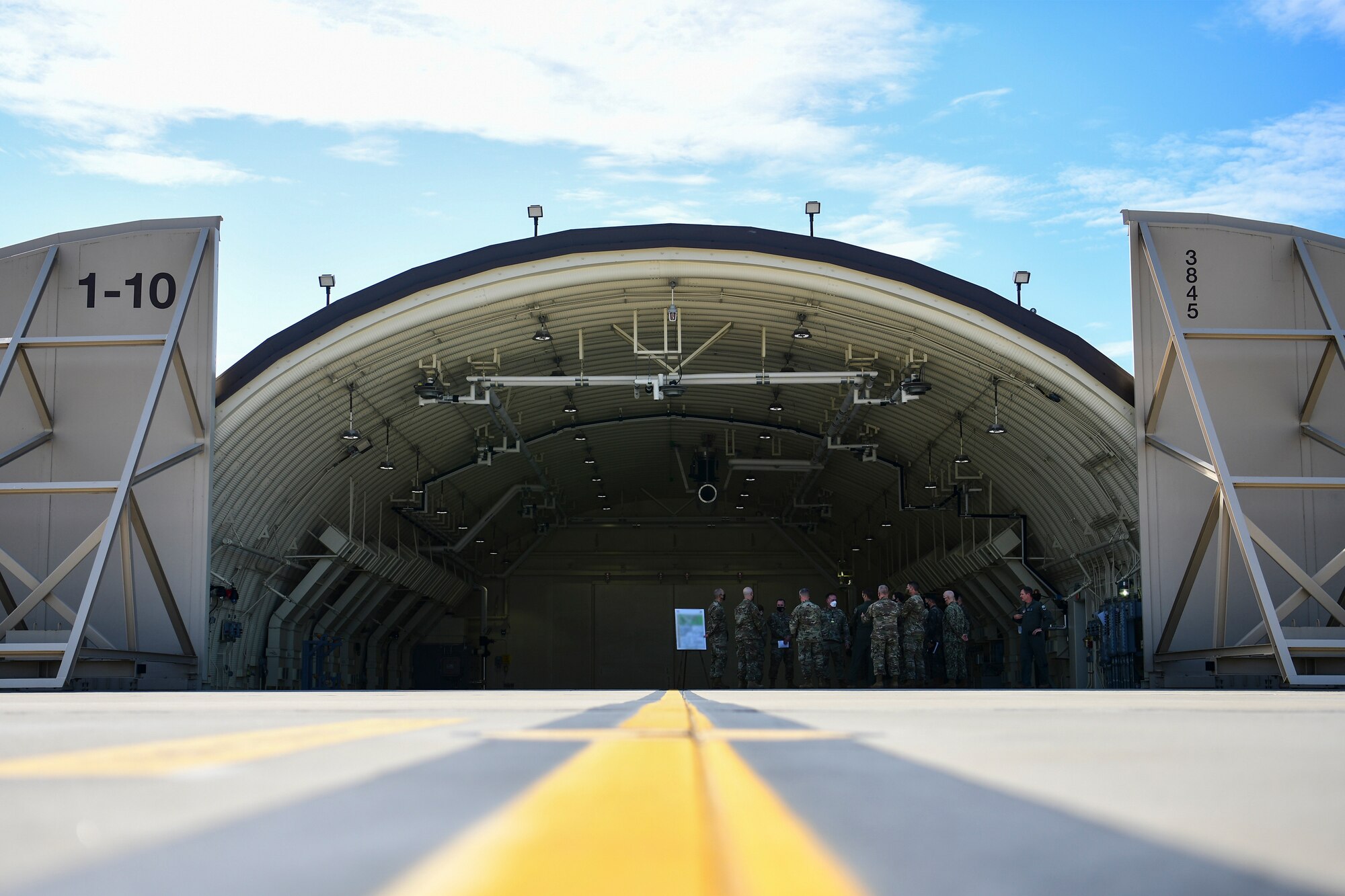 Commanders gather under a hangar.