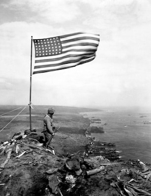 From the crest of Mount Suribachi, the Stars and Stripes wave in triumph over Iwo Jima after U.S. Marines had fought their way inch by inch up its steep lava-encrusted slopes.  Ca.  February 1945.  PhoM3c. John Papsun.  (Coast Guard)
NARA FILE #:  026-G-4140
WAR & CONFLICT BOOK #:  1222