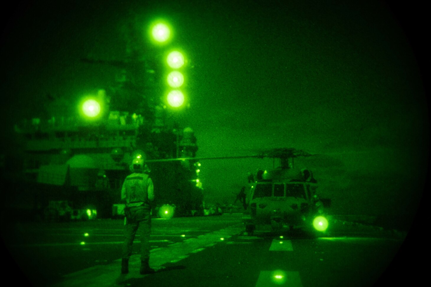 Aviation Boatswain’s Mate (Handling) Airman Jesse Click, from Sylvan Springs, Ala., assigned to the forward-deployed amphibious assault ship USS America (LHA 6), signals an MH-60S Seahawk helicopter from the Helicopter Sea Combat Squadron (HSC) 25. America, flagship of the America Expeditionary Strike Group, along with the 31st Marine Expeditionary Unit, is operating in the U.S. 7th Fleet area of responsibility to enhance interoperability with allies and partners and serve as a ready response force to defend peace and stability in the Indo-Pacific region.