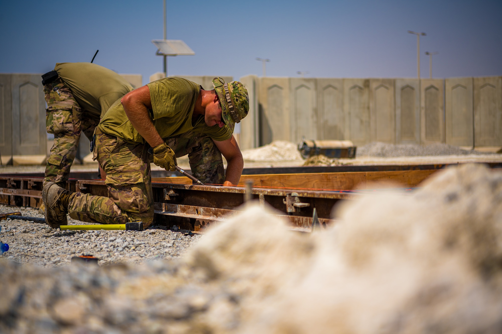 U.S. Air Force Airmen from the 1st Expeditionary Civil Engineer Group (ECEG) and 380th Expeditionary Civil Engineer Squadron lay foundation for expansion at Al Dhafra Air Base, United Arab Emirates, Aug. 18, 2021.