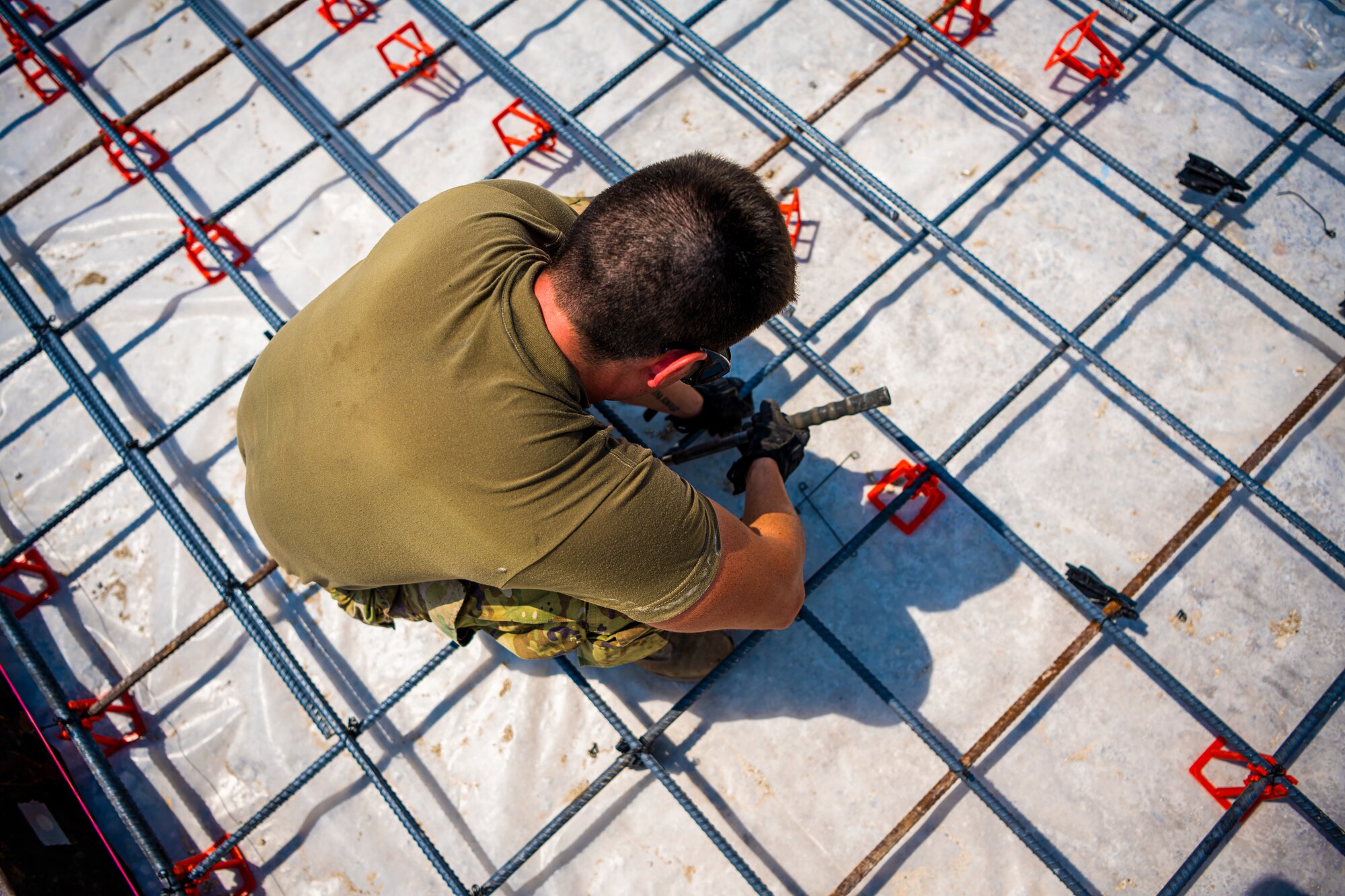 U.S. Air Force Airmen from the 1st Expeditionary Civil Engineer Group (ECEG) and 380th Expeditionary Civil Engineer Squadron lay foundation for expansion at Al Dhafra Air Base, United Arab Emirates, Aug. 18, 2021.