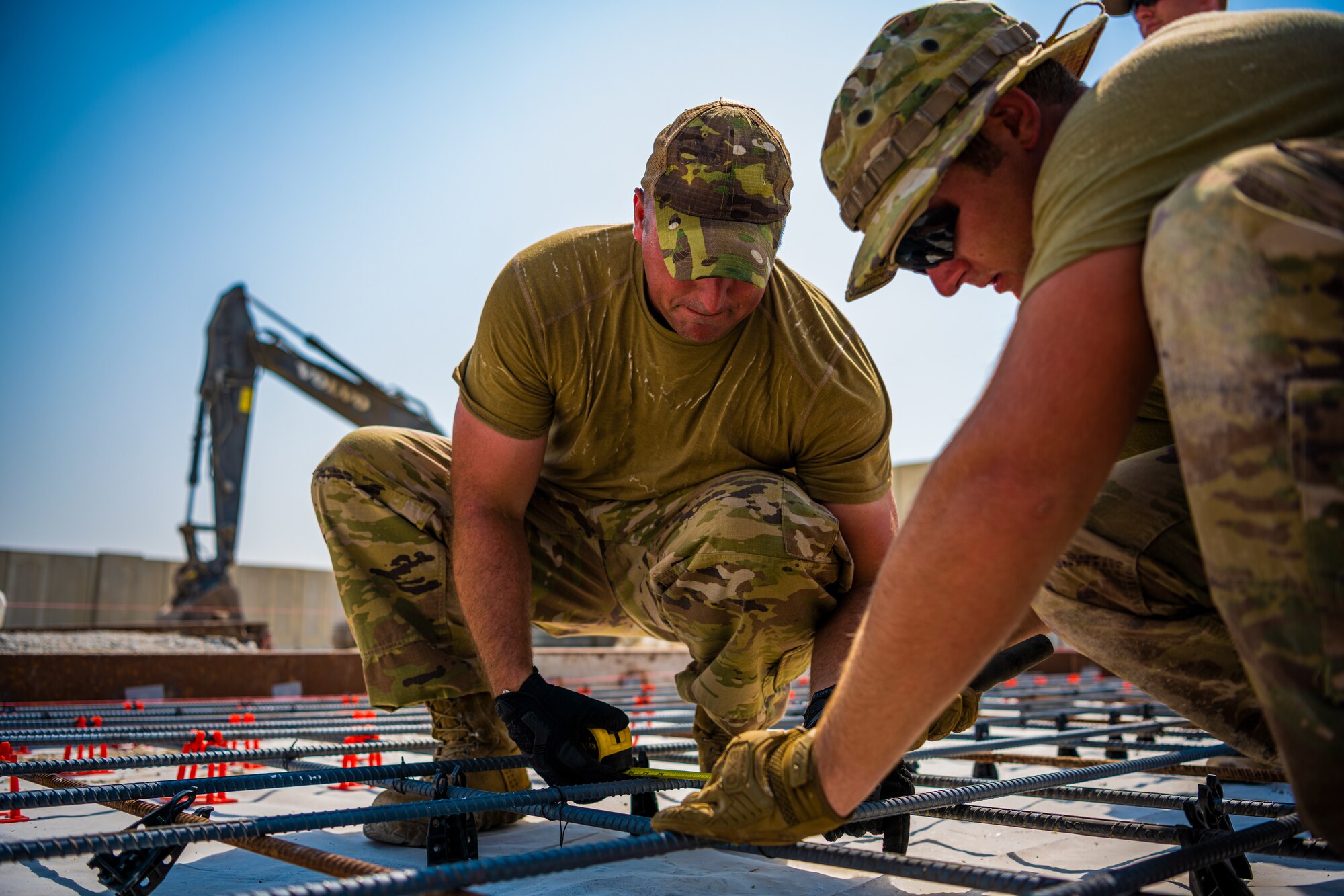 U.S. Air Force Airmen from the 1st Expeditionary Civil Engineer Group (ECEG) and 380th Expeditionary Civil Engineer Squadron lay foundation for expansion at Al Dhafra Air Base, United Arab Emirates, Aug. 18, 2021.