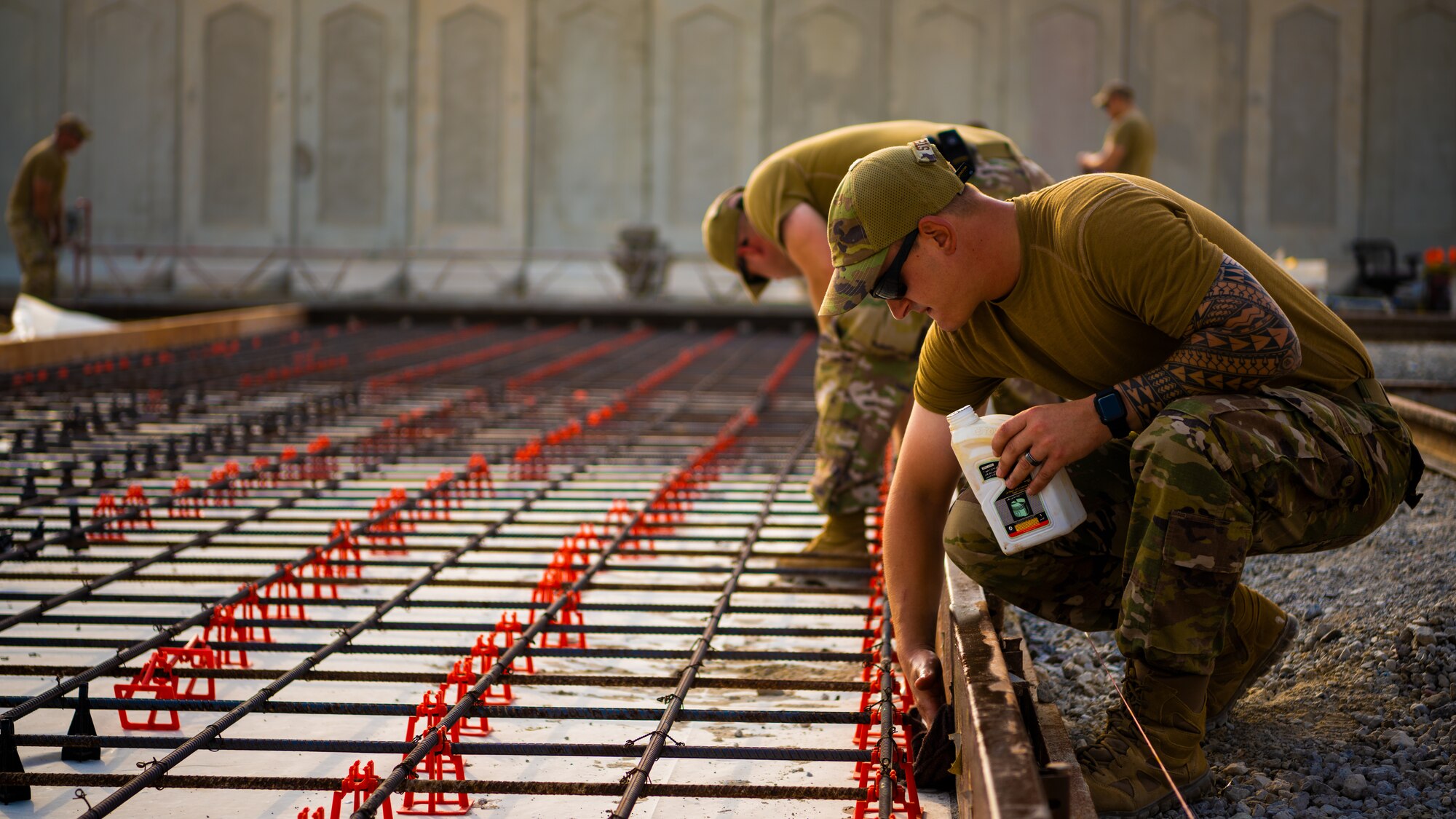 U.S. Air Force Airmen from the 1st Expeditionary Civil Engineer Group (ECEG) and 380th Expeditionary Civil Engineer Squadron lay foundation for expansion at Al Dhafra Air Base, United Arab Emirates, Aug. 18, 2021.