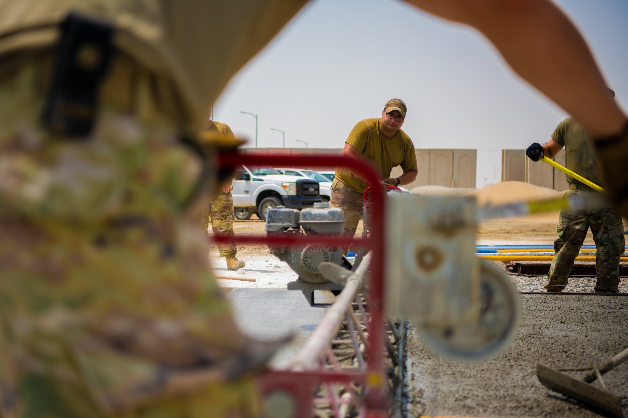 U.S. Air Force Airmen from the 1st Expeditionary Civil Engineer Group (ECEG) and 380th Expeditionary Civil Engineer Squadron lay foundation for expansion at Al Dhafra Air Base, United Arab Emirates, Aug. 18, 2021.