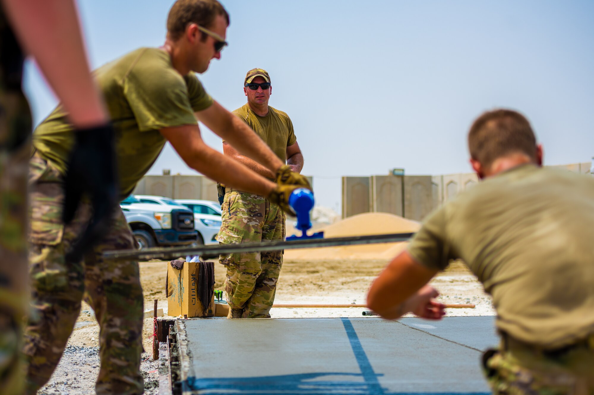 U.S. Air Force Airmen from the 1st Expeditionary Civil Engineer Group (ECEG) and 380th Expeditionary Civil Engineer Squadron lay foundation for expansion at Al Dhafra Air Base, United Arab Emirates, Aug. 18, 2021.