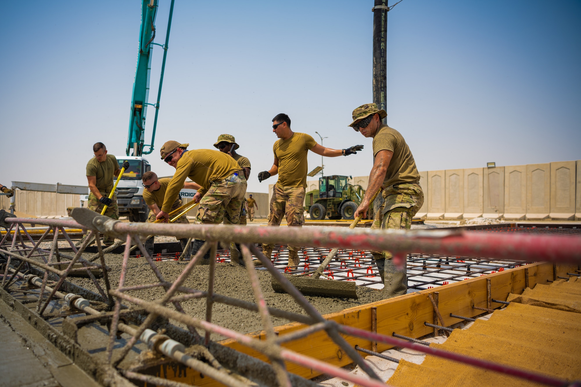 U.S. Air Force Airmen from the 1st Expeditionary Civil Engineer Group (ECEG) and 380th Expeditionary Civil Engineer Squadron lay foundation for expansion at Al Dhafra Air Base, United Arab Emirates, Aug. 18, 2021.