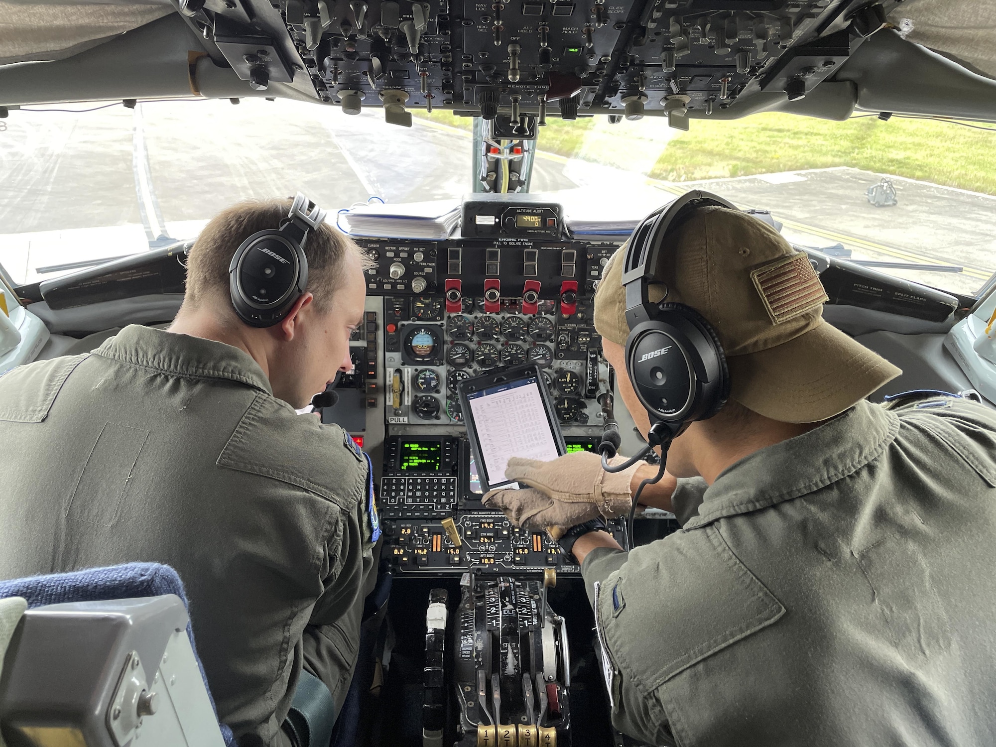 U.S. Air Force Capt. Nicholas Boonstra, 351st Air Refueling Squadron pilot, left, and 1st Lt. Mitchell Hooper, 351st ARS co-pilot, review flight information before a mission at Royal Air Force Mildenhall, England, Aug. 19, 2021. The 100th Air Refueling Wing provides unrivaled air refueling support throughout the European and African areas of responsibility. (U.S. Air Force photo by Senior Airman Joseph Barron)