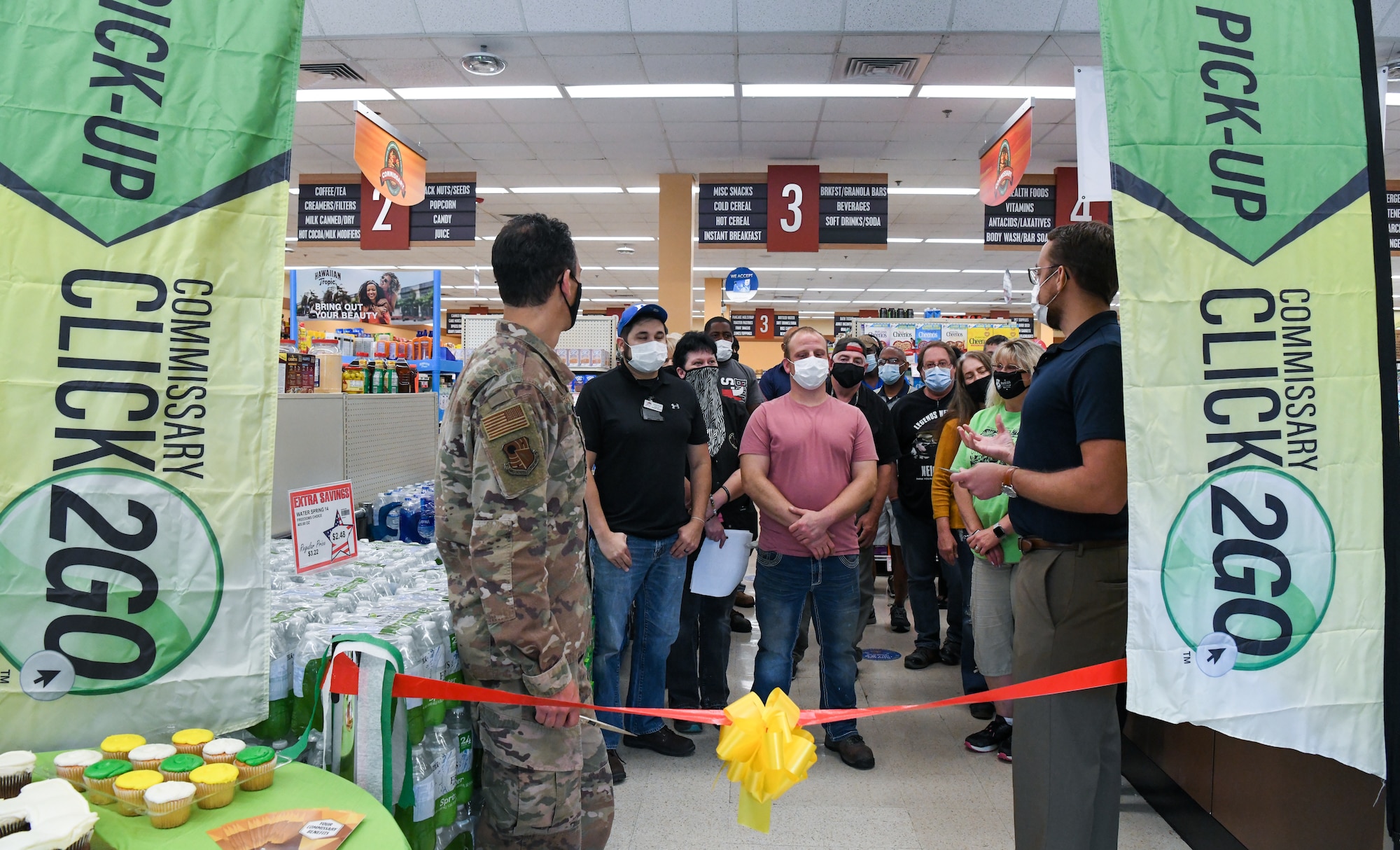 Brandon Jelson, right, Arnold Air Force Base Commissary store director, addresses the staff of the Arnold AFB Commissary before a ribbon cutting for the launch of the CLICK2GO online ordering and curbside pick-up service at the commissary, Aug. 3, 2021, at Arnold AFB, Tenn. Also pictured, left, is Col. Jeffrey Geraghty, commander of Arnold Engineering Development Complex, headquartered at Arnold AFB. (U.S. Air Force photo by Jill Pickett)