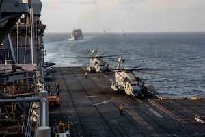 STRAIT OF HORMUZ (Aug. 23, 2021) Amphibious assault ship USS Iwo Jima (LHD 7), U.S. flagged container ship M/V Sagamore, and dry cargo and ammunition ships USNS Wally Schirra (T-AKE 8) and USNS Cesar Chavez (T-AKE 14) transits the Strait of Hormuz, Aug. 23. Iwo Jima is deployed to the U.S. 5th Fleet area of operations in support of naval operations to ensure maritime stability and security in the Central Region, connecting the Mediterranean and Pacific through the western Indian Ocean and three strategic choke points. (U.S. Navy photo by Mass Communication Specialist Seaman Isaac A. Rodriguez)