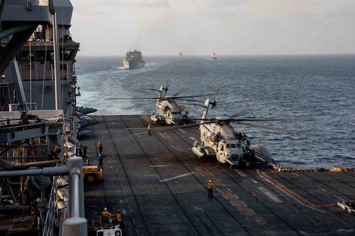 STRAIT OF HORMUZ (Aug. 23, 2021) Amphibious assault ship USS Iwo Jima (LHD 7), U.S. flagged container ship M/V Sagamore, and dry cargo and ammunition ships USNS Wally Schirra (T-AKE 8) and USNS Cesar Chavez (T-AKE 14) transits the Strait of Hormuz, Aug. 23. Iwo Jima is deployed to the U.S. 5th Fleet area of operations in support of naval operations to ensure maritime stability and security in the Central Region, connecting the Mediterranean and Pacific through the western Indian Ocean and three strategic choke points. (U.S. Navy photo by Mass Communication Specialist Seaman Isaac A. Rodriguez)