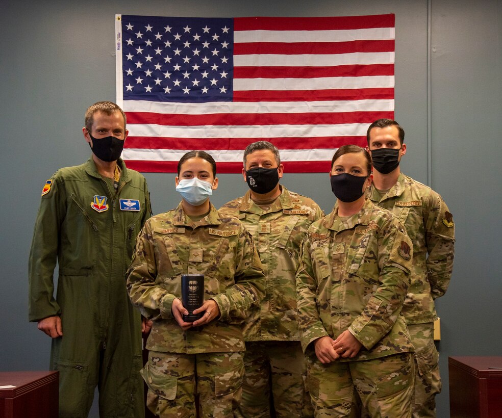 An Airman and her leadership pose for a photo.