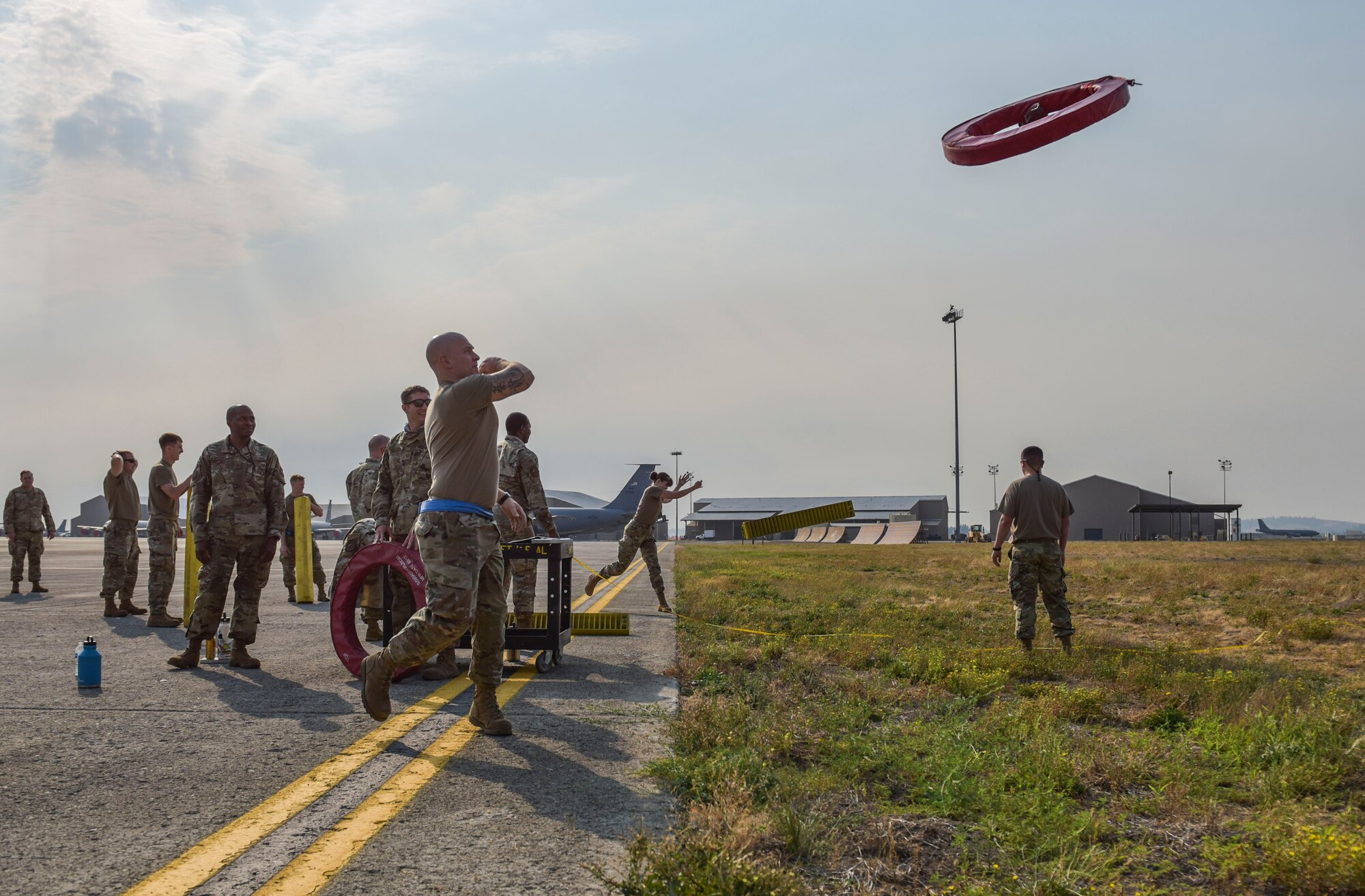 Members of the 92nd Maintenance Group compete in throwing games at the Maintenance Olympics event at Fairchild Air Force Base, Washington, Aug. 20, 2021.