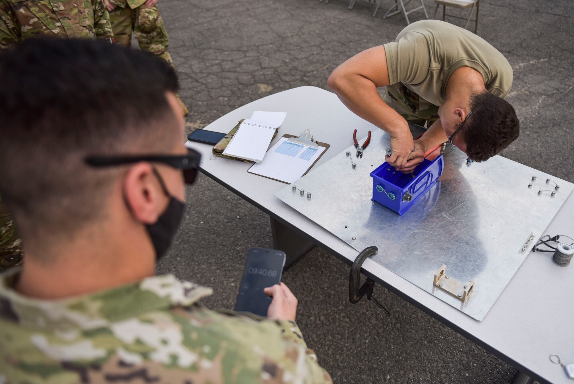 U.S. Air Force Airman 1st Class Matthew Ellis, 92nd Aircraft Maintenance Squadron Kc-135 Stratotanker crew chief, ties safety wire to secure bolts together during a timed event at the Maintenance Olympics event at Fairchild Air Force Base, Washington, Aug. 20, 2021.