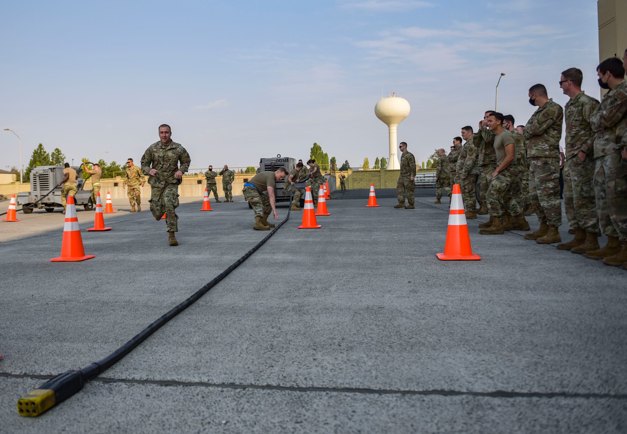 Members of the 92nd Maintenance Group compete in a power cart obstacle course race at the Maintenance Olympics event at Fairchild Air Force Base, Washington, Aug. 20, 2021.
