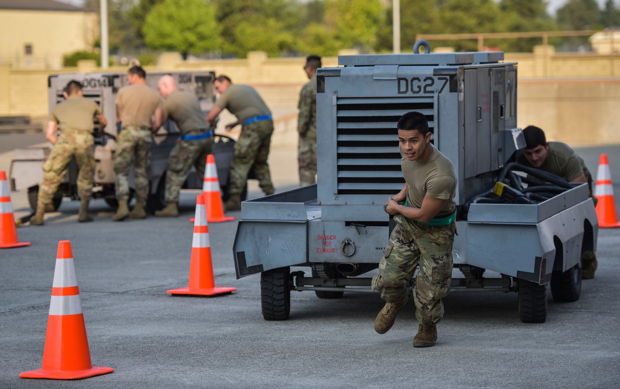 Members of the 92nd Maintenance Squadron and the 92nd Aircraft Maintenance Squadron compete in a power cart obstacle course race at the Maintenance Olympics event at Fairchild Air Force Base, Washington, Aug. 20, 2021.
