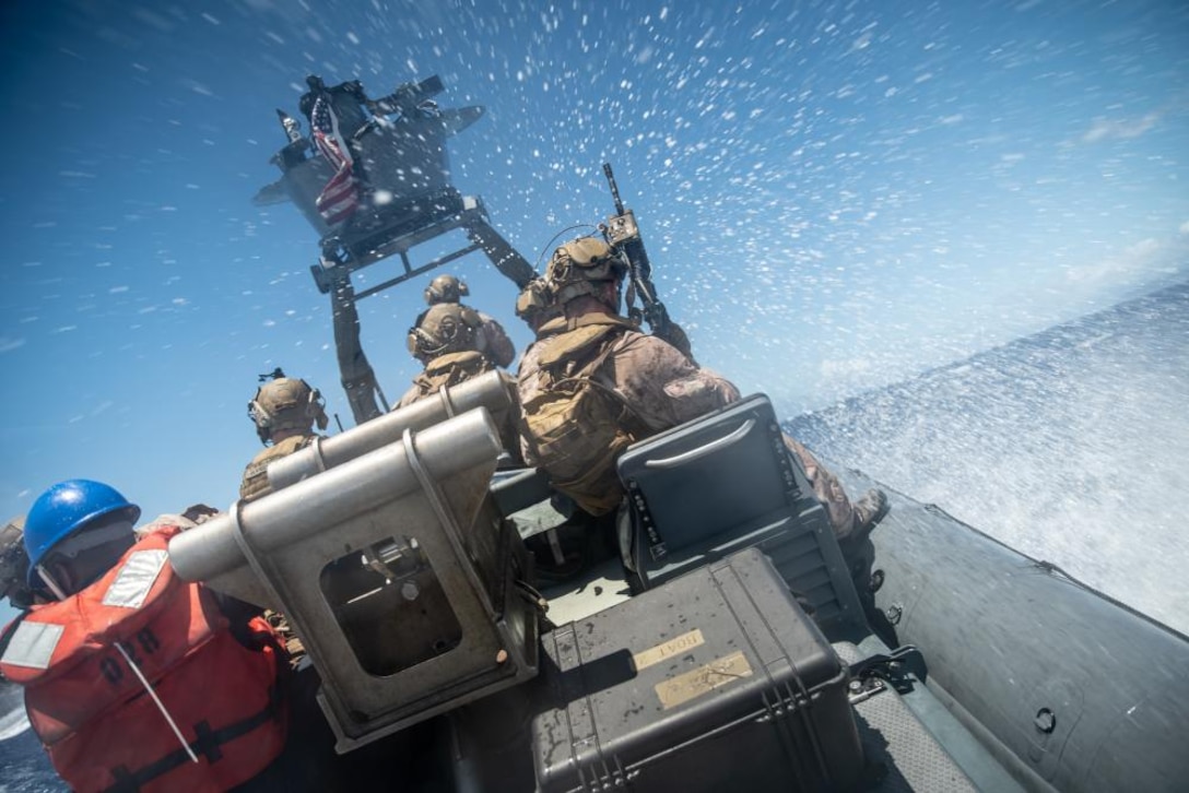 U.S. Marines with the All Domain Reconnaissance boat team, 11th Marine Expeditionary Unit, operate a rigid inflatable boat during touch-and-go training, Aug. 13. Marines and Sailors of the 11th MEU and Essex Amphibious Ready Group are underway conducting routine operations in U.S. 3rd Fleet.