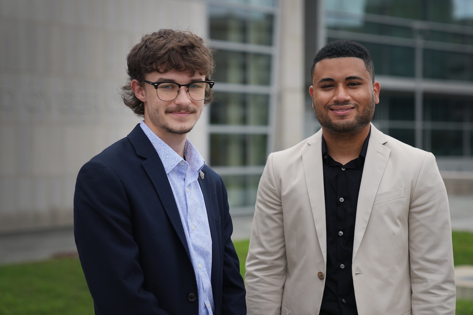 Ethan Marshall (left) and Jimmy Rodriguez, U.S. Air Force Premier College Interns, stand near the U.S. Cyber Command Integrated Cyber Center at Fort George G. Meade, Md., Aug. 18, 2021.
