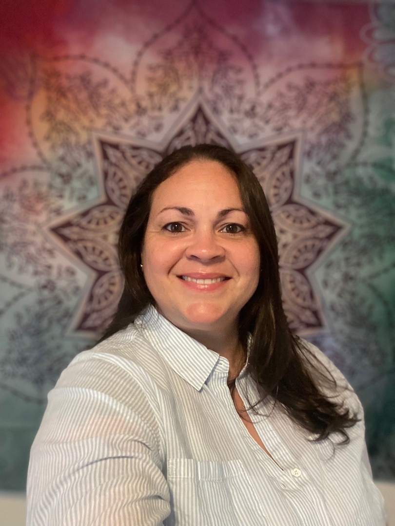 A photo of a woman, Claudia Rabaza, smiling into the camera.