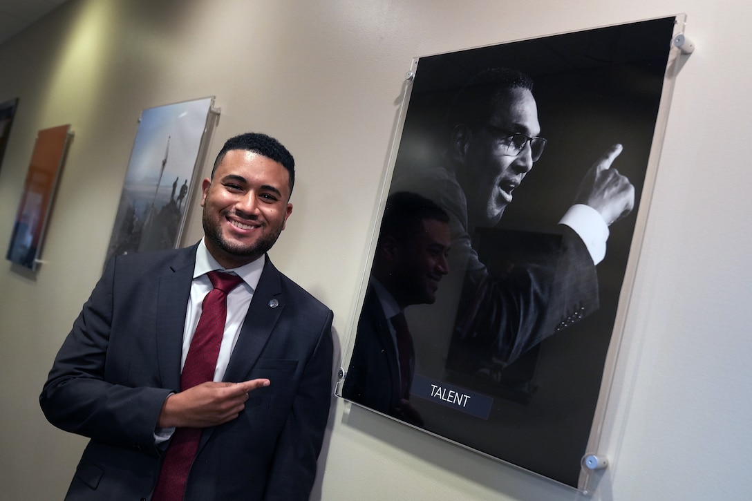 Rodriguez, U.S. Air Force Premier College Intern, points to a portrait of his college president, Freeman Hrabowski, University of Maryland, Baltimore County, hanging in the offices of Gen. Paul M. Nakasone, U.S. Cyber Command commander and National Security Agency director, at Fort George G. Meade, Md., Aug. 18, 2021.