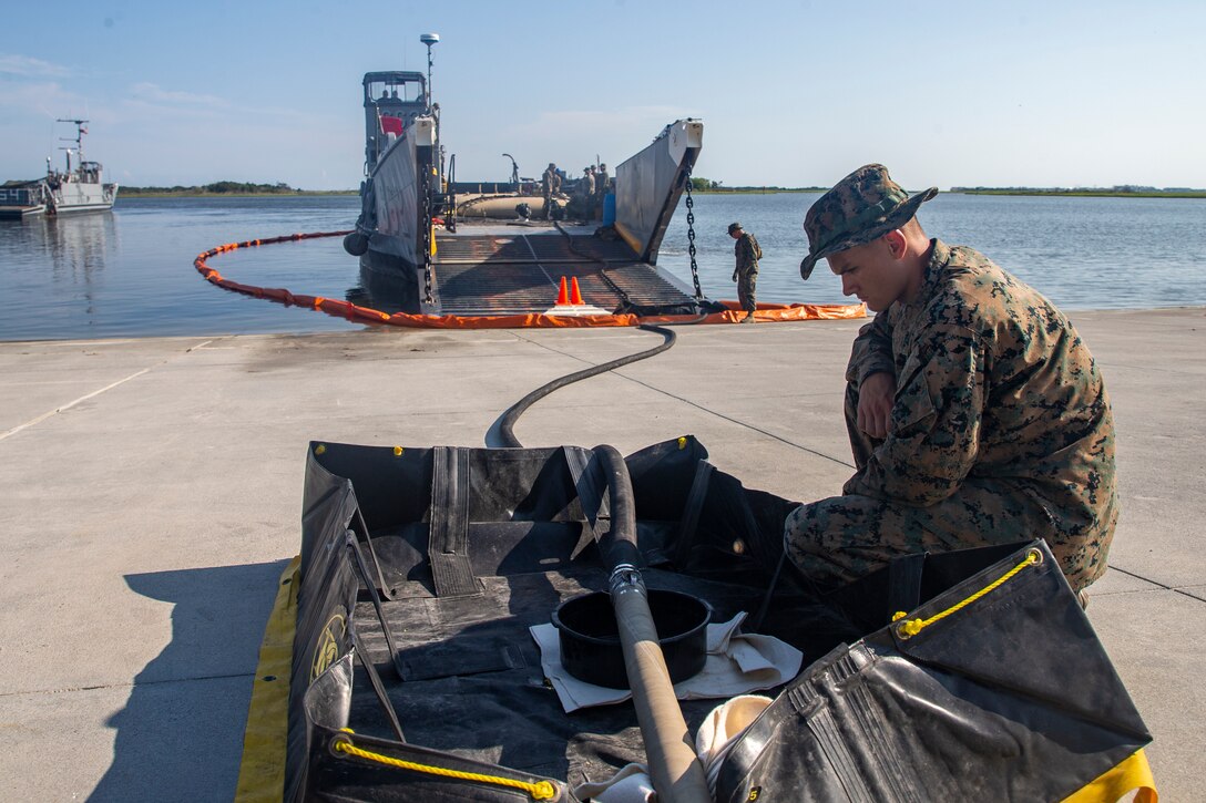 U.S. Marines and Sailors conduct a landing craft utility fuel transfer during Large Scale Exercise 2021 (LSE 2021) at Camp Lejeune, North Carolina, Aug. 8, 2021. LSE 2021 demonstrates the Navy’s ability to employ precise, lethal, and overwhelming force globally across three naval component commands, five numbered fleets, and 17 time zones. LSE 2021 merges live and synthetic training capabilities to create an intense, robust training environment. It will connect high-fidelity training and real-world operations, to build knowledge and skills needed in today’s complex, multi-domain, and contested environment. (U.S. Marine Corps Photo by Cpl. Christian M. Garcia)
