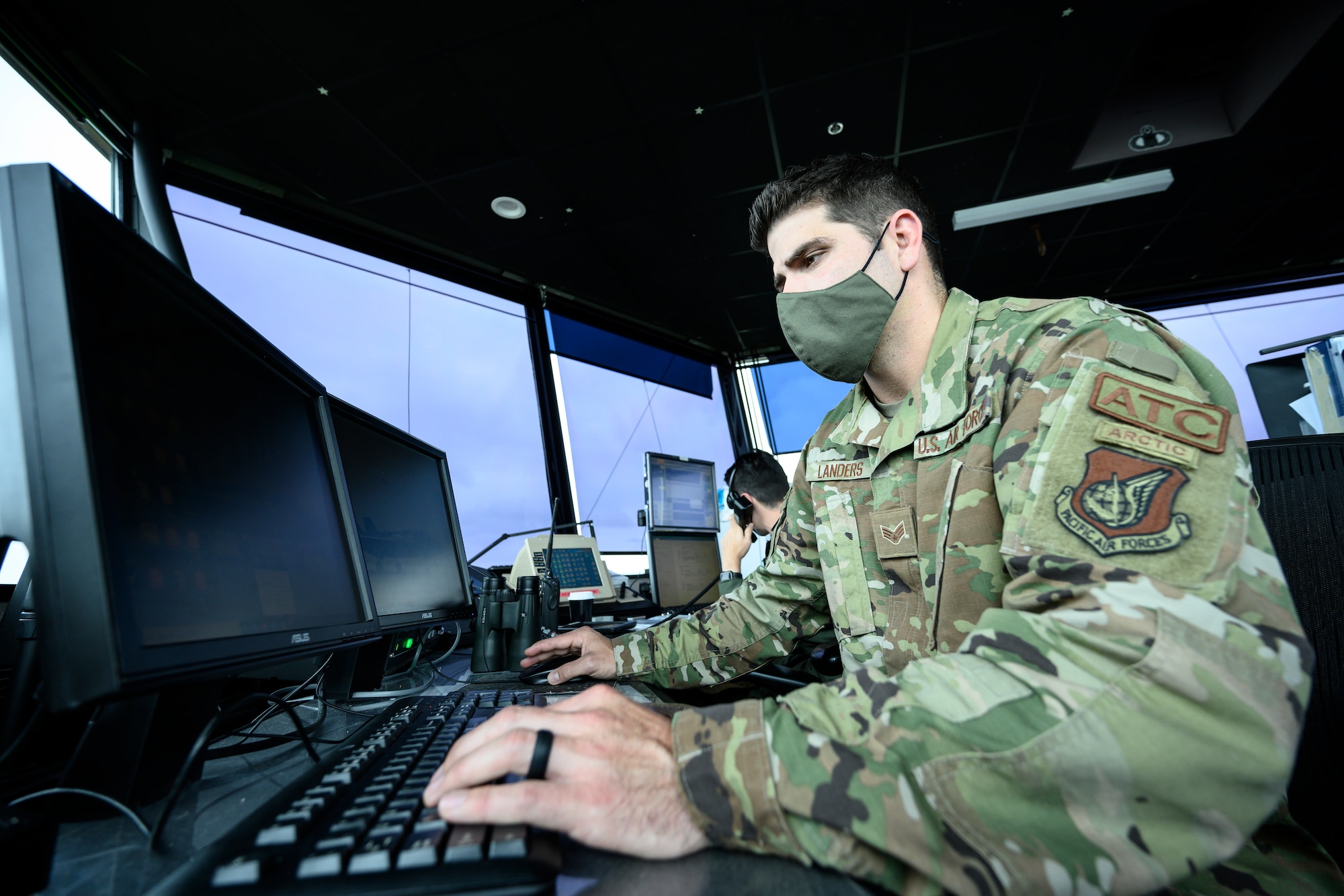 Senior Airman Mark Landers, 354th Operations Support Squadron air traffic controller, monitors flights from the air traffic control tower at Eielson Air Force Base, Alaska, Aug. 19, 2021. From the Eielson AFB ATC tower, ATCs like Landers ensure the safety of aircraft from fighter jets to cargo planes to helicopters during their take-offs and landings. (U.S. Air Force photo by Staff Sgt. Christian Conrad)