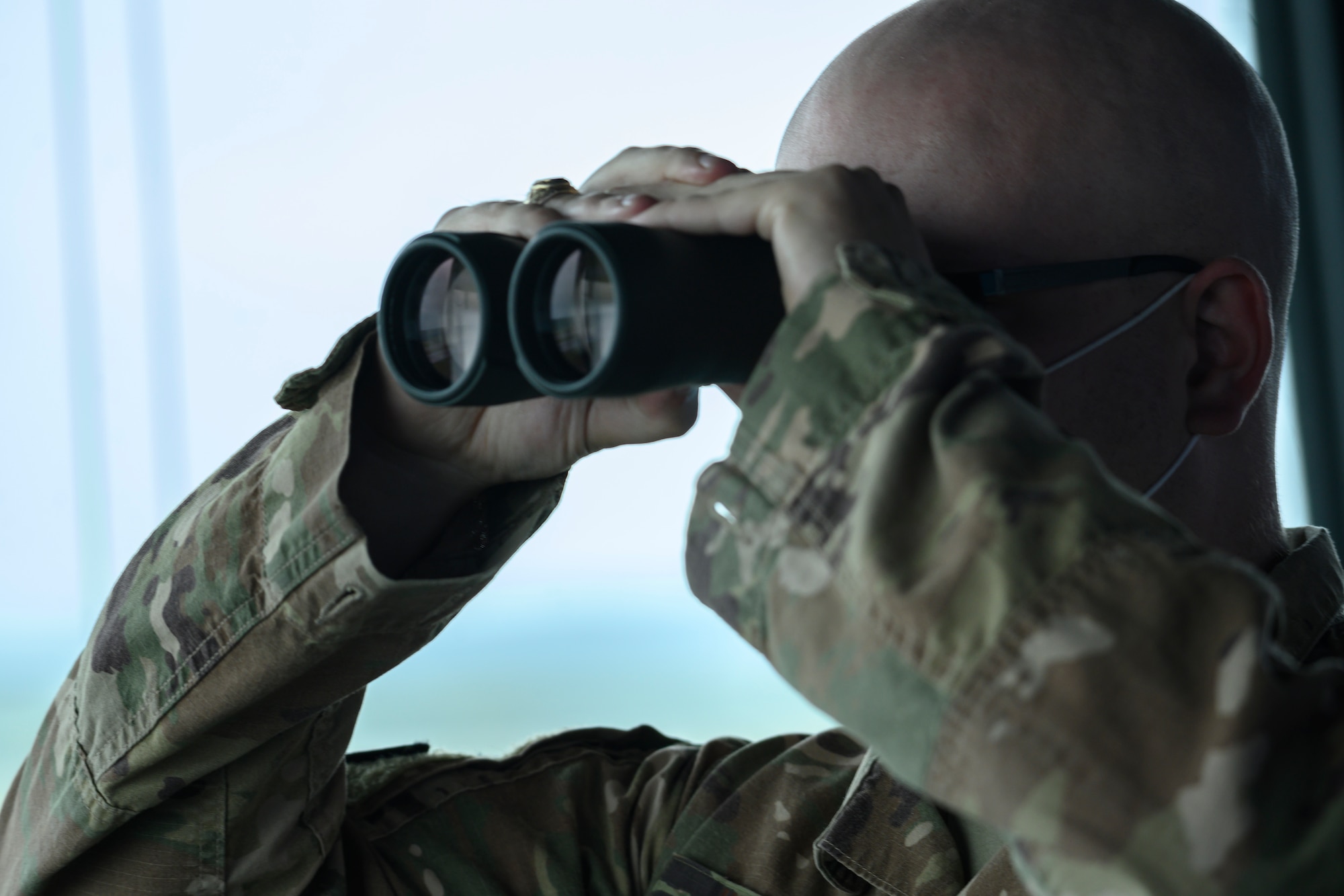 U.S. Air Force Staff Sgt. Kevin Weast, 354th Operations Support Squadron air traffic controller, surveys the flight line at Eielson Air Force Base, Alaska, Aug. 19, 2021. During Red Flag 21-3, held Aug. 12 – 27, ATC specialists at Eielson AFB encountered a significant increase to their daily operations, monitoring an average of 210 flights a day. (U.S. Air Force photo by Staff Sgt. Christian Conrad)