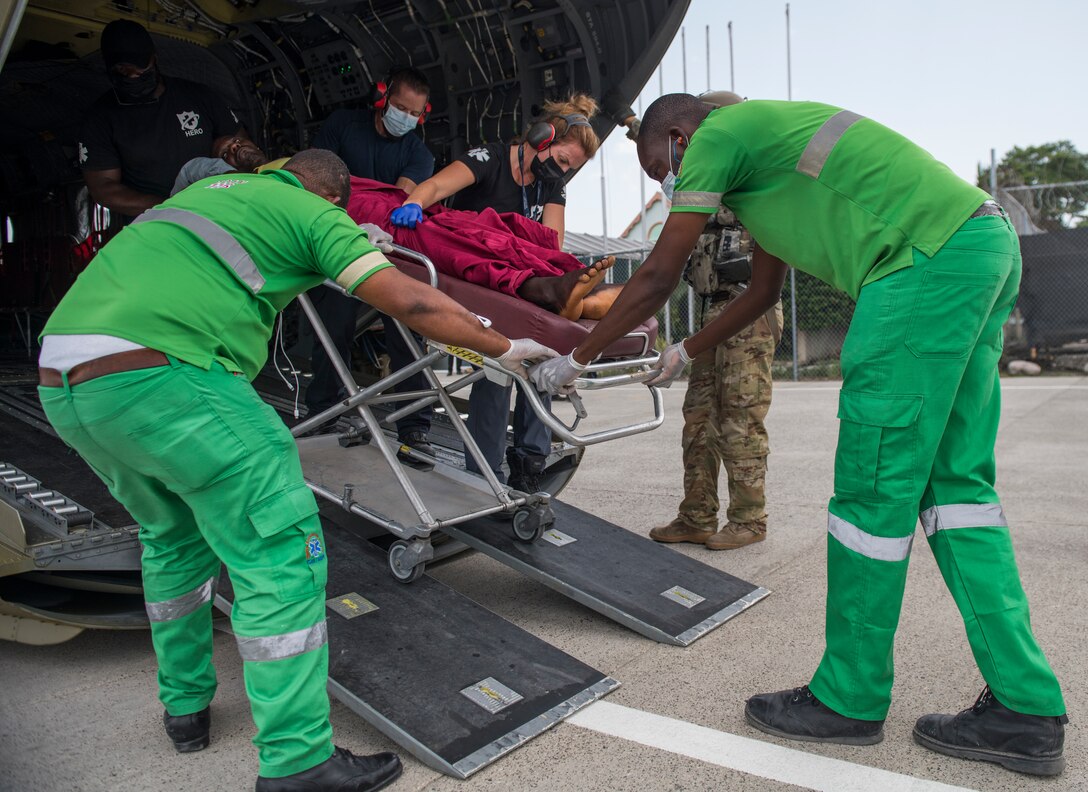 Medical volunteers transport a patient to medical care from a U.S. Army CH-47 Chinook helicopter assigned to the 1st Battalion, 228th Aviation Regiment, Joint Task Force-Bravo, Soto Cano Air Base, Honduras, after a disaster relief mission at Port-au-Prince, Haiti, Aug. 24, 2021.