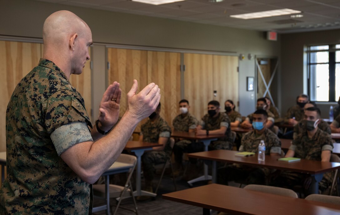 U.S. Marine Sgt. Maj. Troy E. Black, the Sergeant Major of the Marine Corps, recognizes Marines of 8th Marine Corps Recruiting District on Naval Air Station Joint Reserve Base, Fort Worth, Texas, May 6, 2021. Black gives challenge coins to the recognized Marines. (U.S. Marine Corps photo by Lance Cpl. Hannah Hollerud)