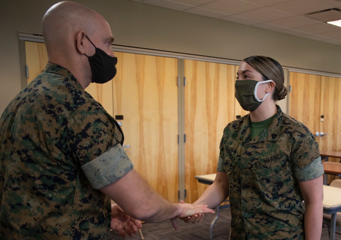 U.S. Marine Sgt. Maj. Troy E. Black, the Sergeant Major of the Marine Corps, recognizes Marines of 8th Marine Corps Recruiting District on Naval Air Station Joint Reserve Base, Fort Worth, Texas, May 6, 2021. Black gives challenge coins to the recognized Marines. (U.S. Marine Corps photo by Lance Cpl. Hannah Hollerud)