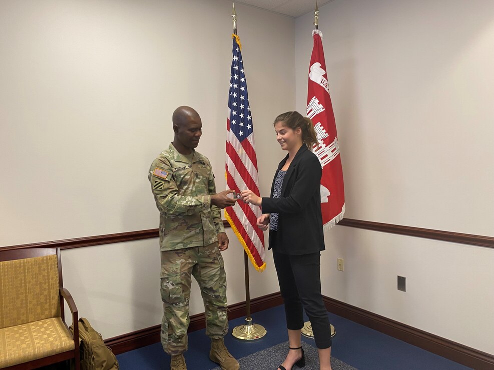 University of Virginia engineering student Sally Sydnor receives a coin from USACE Command Sergeant Major Patrickson Toussaint for her work with the district during the summer of 2021.