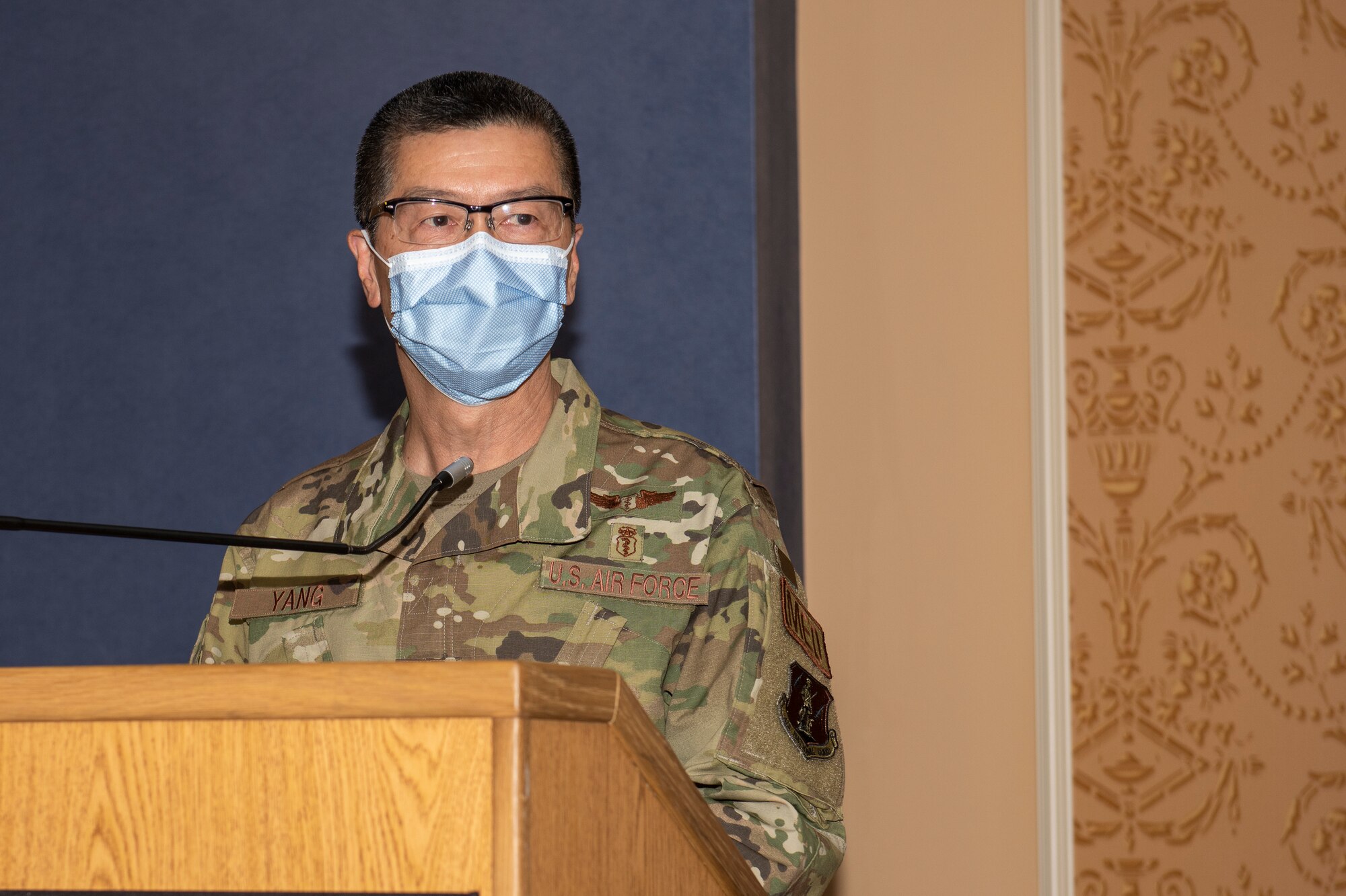 Col. Frank Y. Yang stands at the podium after assuming command of the 192nd Medical Group.