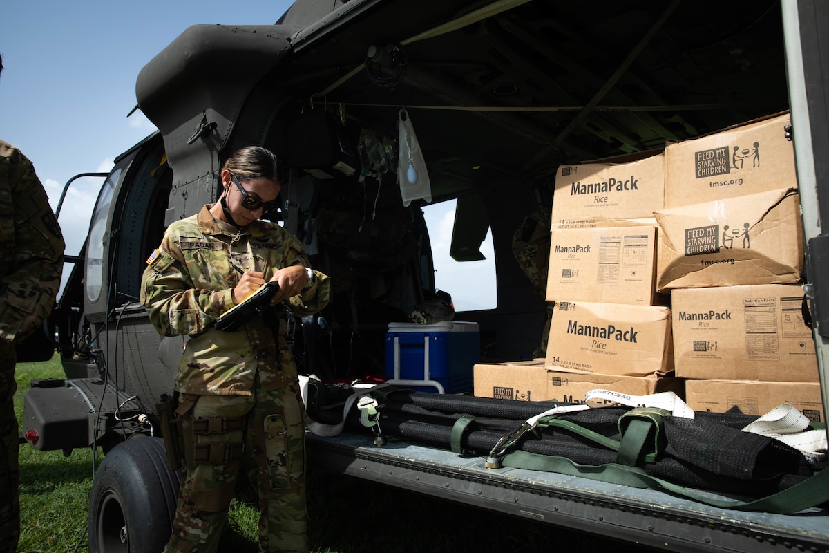 Warrant Officer (WO1) Adaliz Pagan performs an inventory check before transporting food provisions to the community of Jeremie, Haiti, Aug. 24, 2021.