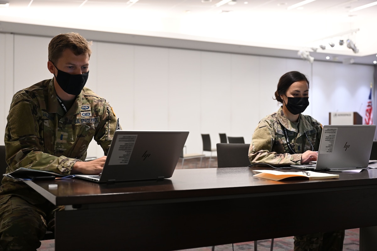 U.S. Space Force 1st Lieutenants John Valentine, left, and Nicole Quattrociocchi, both Portfolio Architect Mission Innovation officers, work on their computers during the first inaugural Space Force Pitch Day Aug. 18, 2021, at Los Angeles Air Force Base, California. This year, SFPD was entirely virtual and featured two days of innovative collaboration between the Air and Space Forces and space industry companies from within the innovation ecosystem. (U.S. Space Force photo/ Staff Sgt. Andrew Moore)