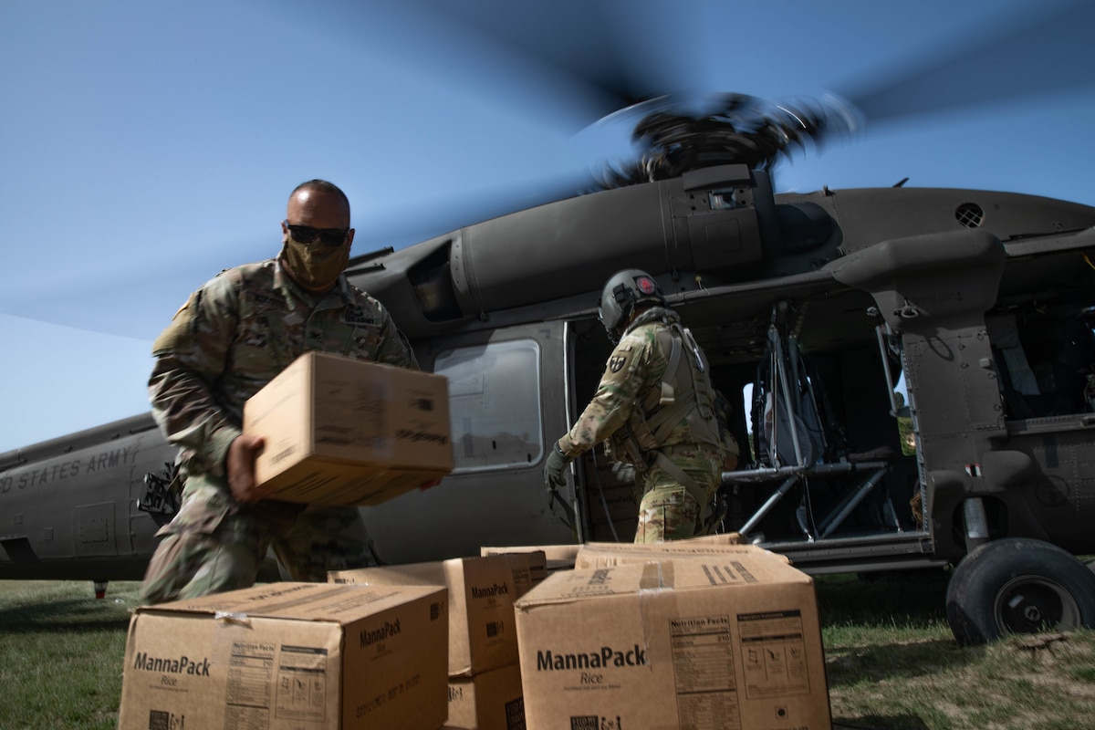 Col. Samuel Agosto, Chief of Staff of the Puerto Rico National Guard, assists with the unloading of food supplies to the community of Anse au Veau, Haiti, Aug. 24, 2021. Guardsmen from the PRANG have been assisting in the aid-relief efforts in the country since Aug. 17. (Army National Guard photo by Sgt. Agustin Montanez/Released)