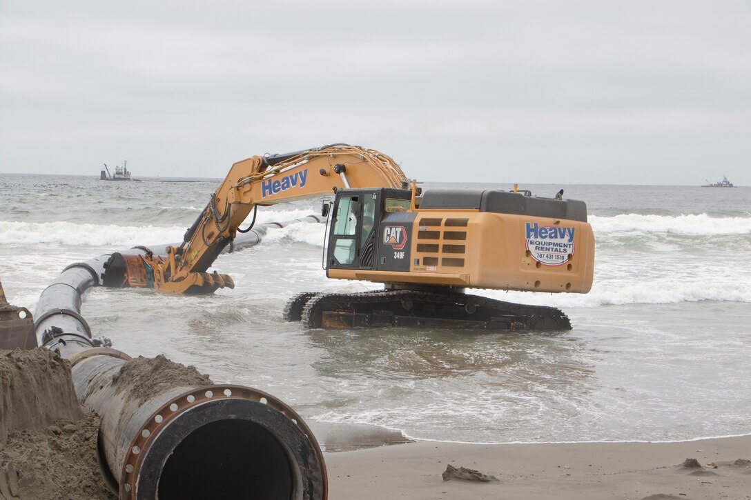 Sand, beach, ocean and construction equipment
