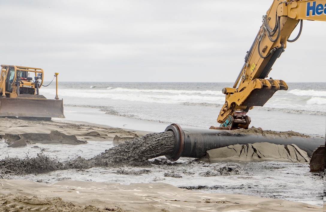 Sand, beach, ocean and construction equipment