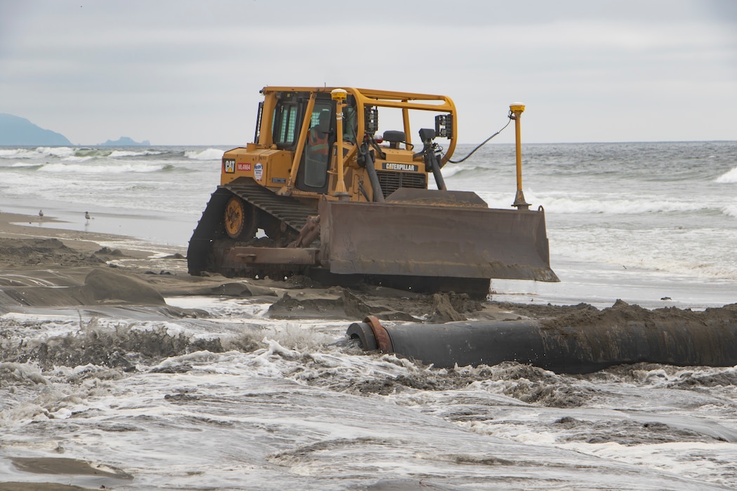 Sand, beach, ocean and construction equipment
